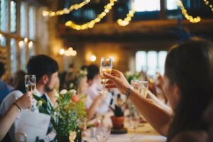 Guests raise their glasses at a wedding party