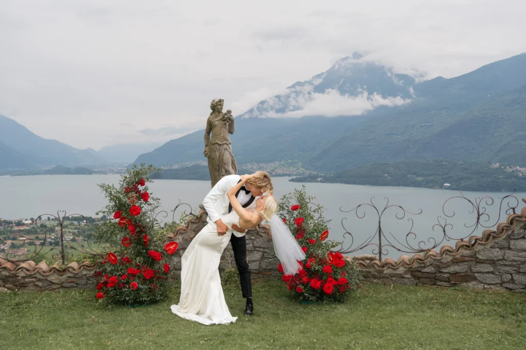 Bride and groom sharing a romantic moment at Villa Evelina with the expansive Lake Como and Alps in the background.