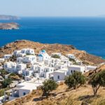 Rustic Cycladic windmill overlooking the Aegean Sea on a rugged island