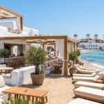Glamorous Mykonos beach club wedding venue with windmills in the background.